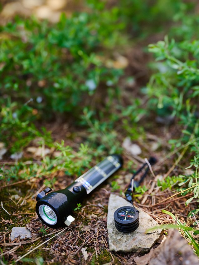 HaloXT laying on the ground with the compass attachment sitting next to it on a rock