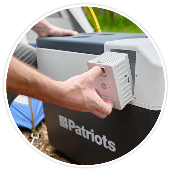 Hand inserting 4Patriots Solar Go-Fridge battery into the 4Patriots Solar Go-Fridge