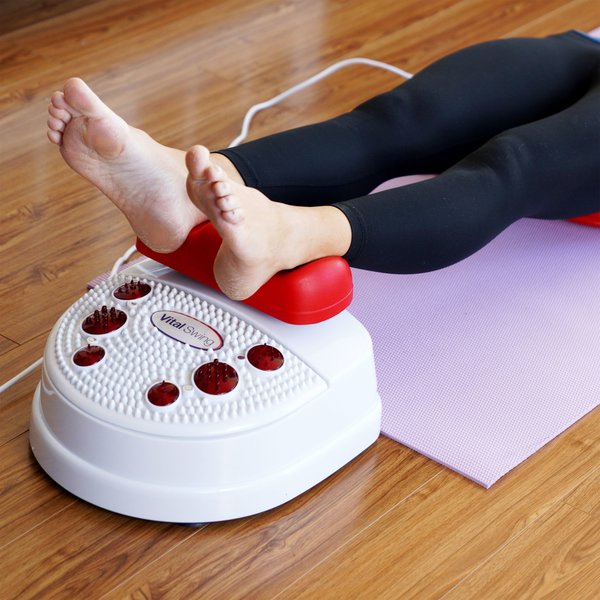 Person laying down putting their feet on the 4Patriots Vital Swing Therapeutic Wellness Machine