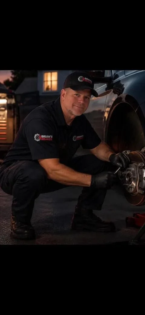 Mobile brake technician working on a vehicle in a driveway