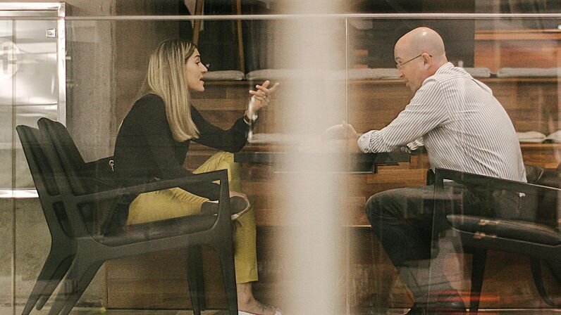 Two coworkers having a conversation.