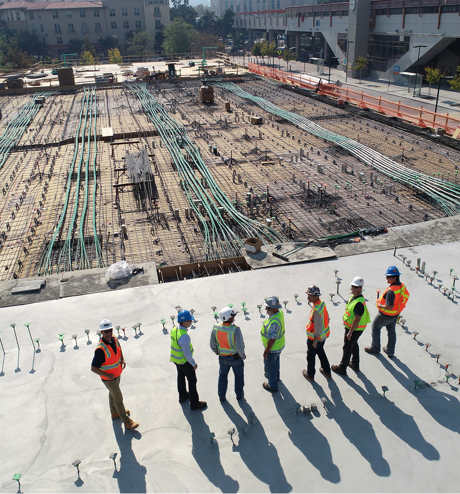 Team of construction workers overlooking a jobsite.