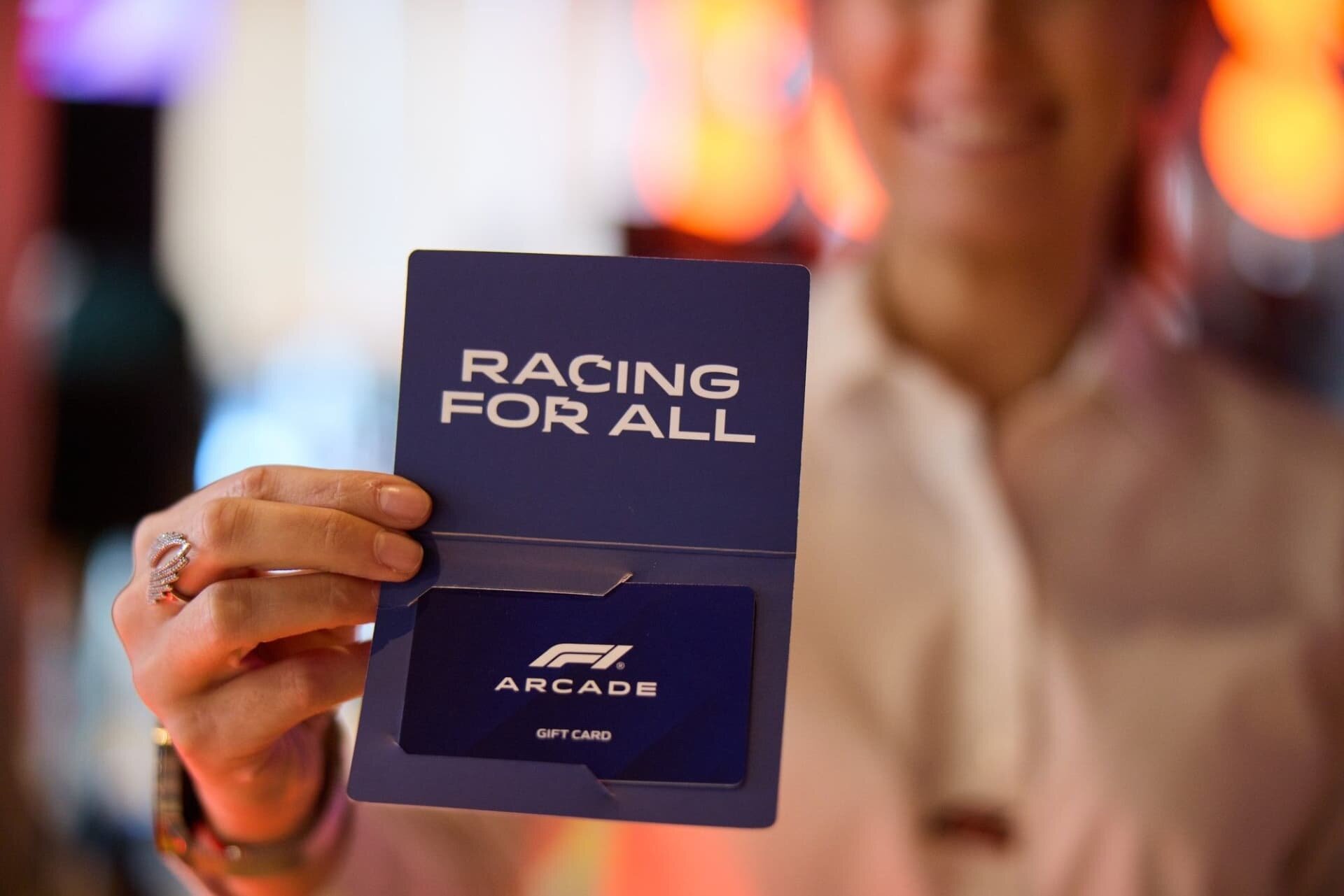 Team member showing off F1 Arcade Gift Card