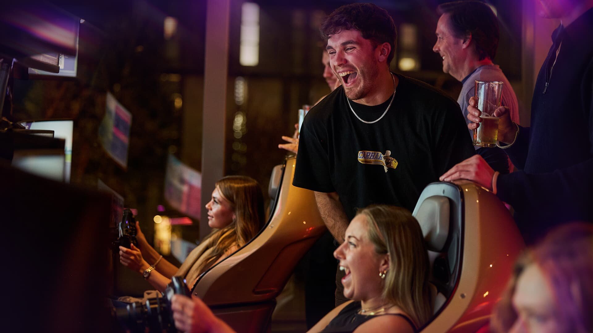 People smiling and enjoying F1 Arcade