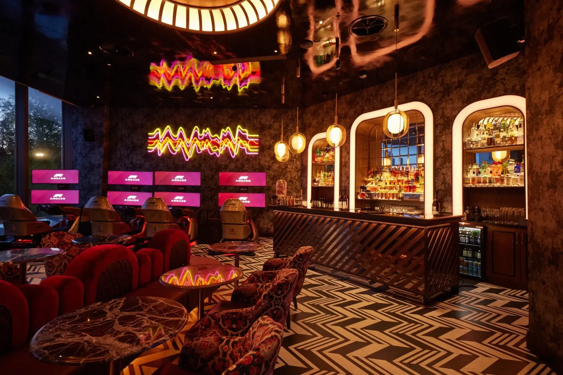 People in F1® Arcade laughing as they race