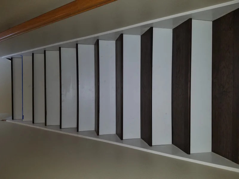 Custom staircase with alternating white and dark wood risers
