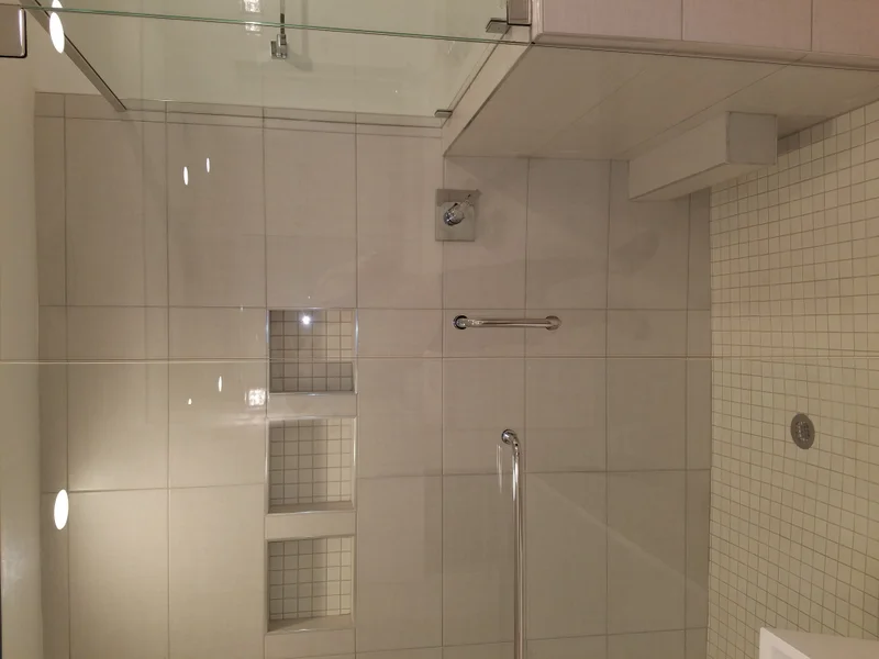Finished tile shower with built-in storage niches