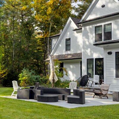 patio in the backyard of a white 2-story home