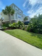 Manicured lawn and tropical foundation landscaping at a coastal home