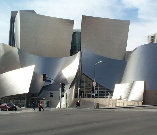 The Walt Disney Concert Hall in Los Angeles, showcasing its distinctive modern architecture and gleaming metallic exterior.