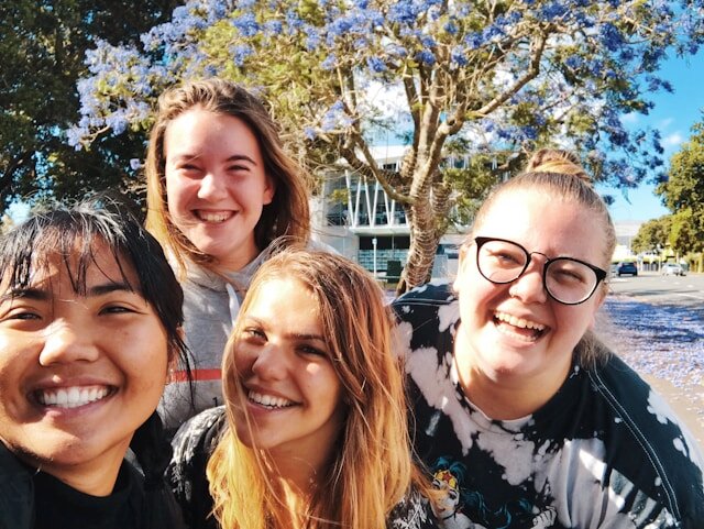 Group of girls outdoors smiling.
