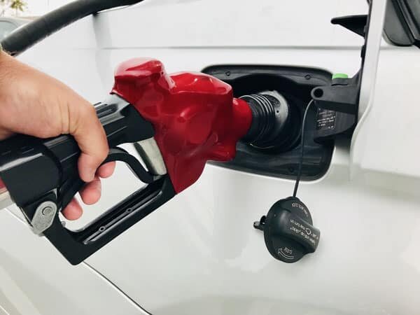 A person pumping gas at a gas station