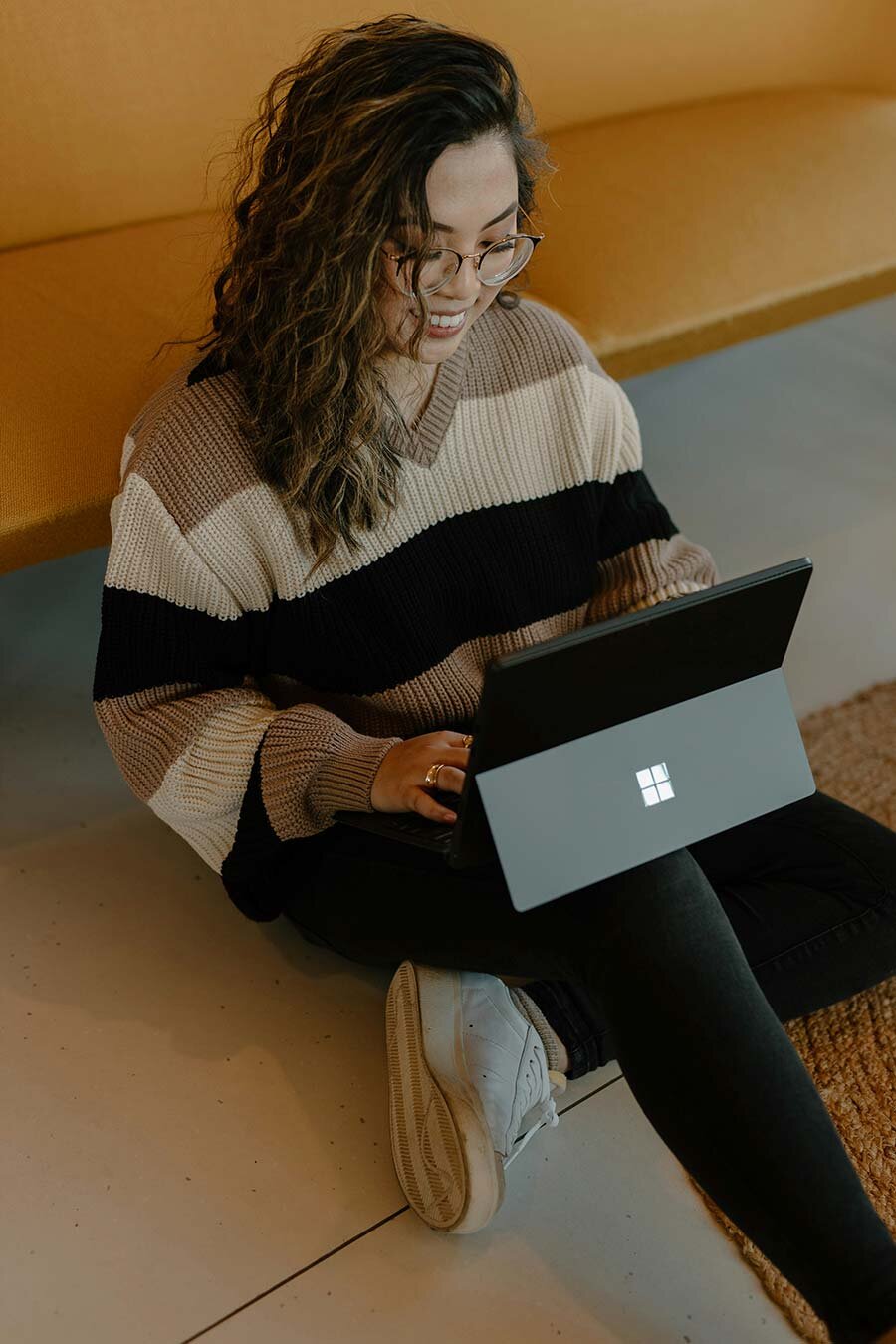 Woman sitting on the floor using a laptop
