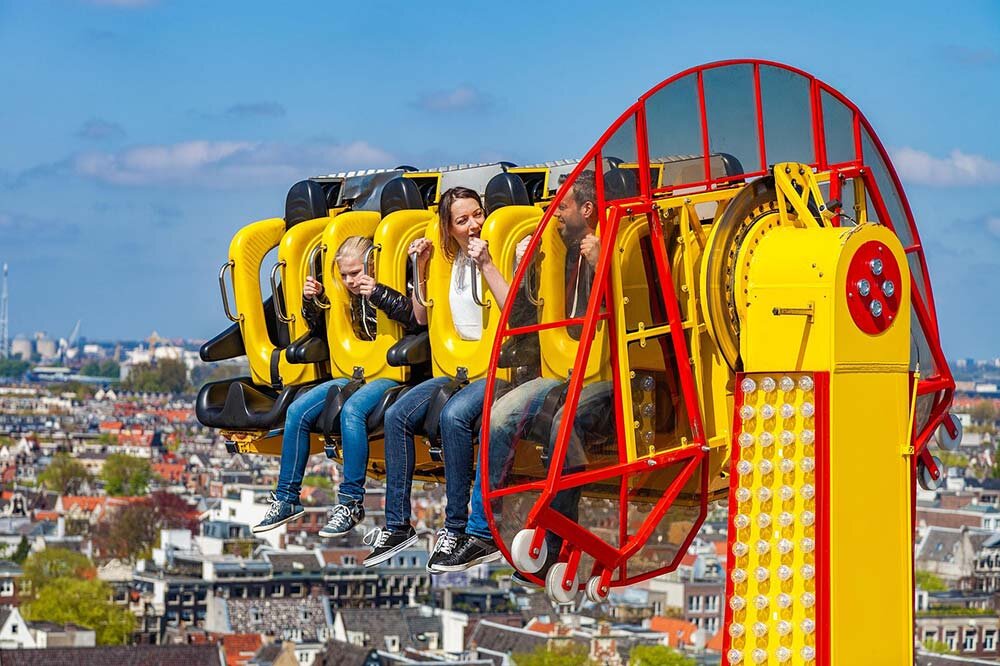 Family of three on a theme park ride.