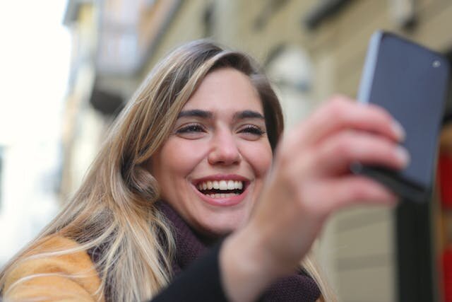 Smiling woman reviewing a line of credit approval on her smartphone.
