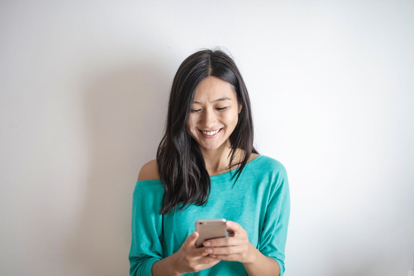 Young woman using a smartphone to apply for a line of credit.