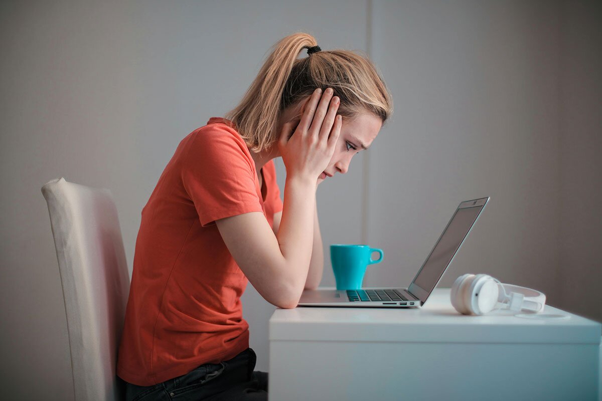 Perplexed woman using laptop and wondering what the best option is for debt consolidation.