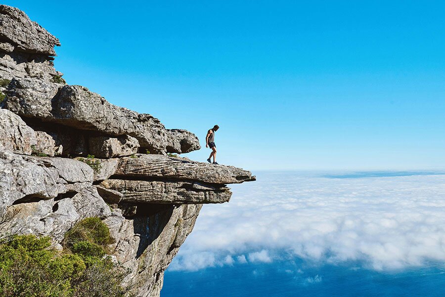 Man positioned near a rock ledge