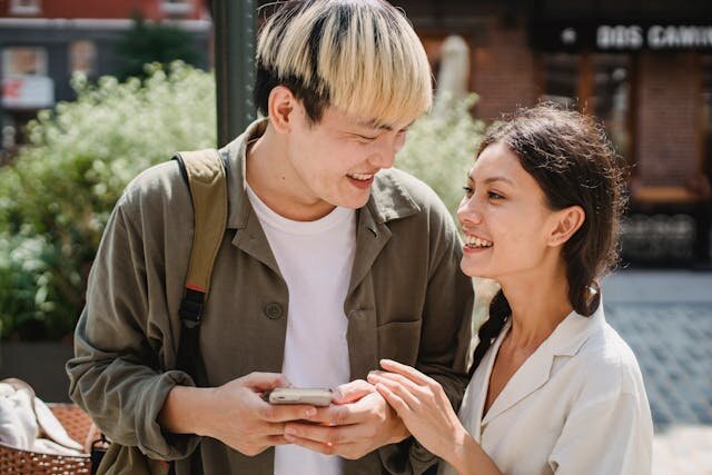 Young multiethnic couple happy about receiving approval for a line of credit in Kansas.