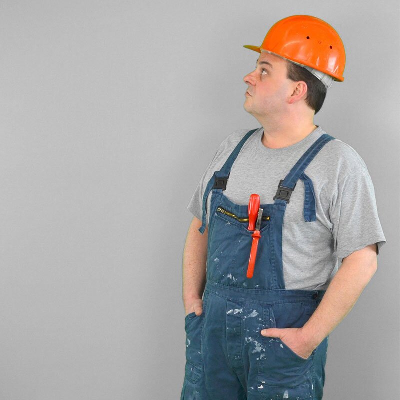 Handyman inspecting a home before repair work starts.