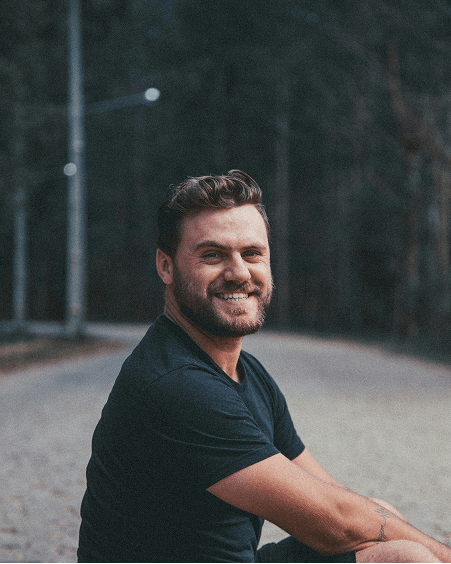 Man sitting on the road smiling