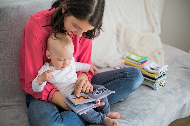 Young mother with an infant on her lap