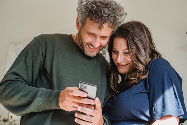 Utah couple reviewing personal loan offer on a smartphone