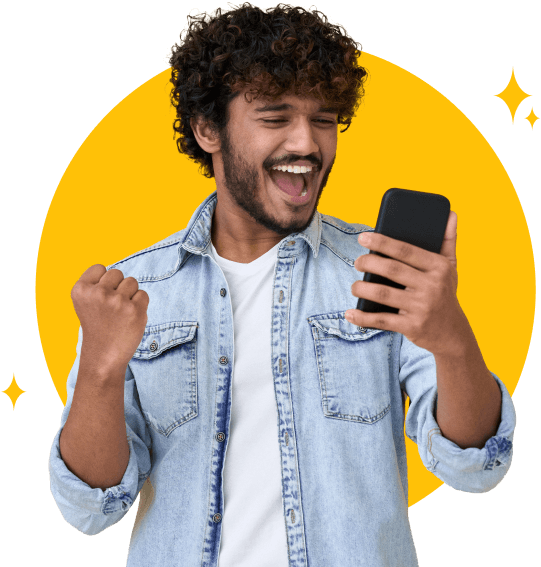 Young man looking triumphantly at his cellphone to see his installment loan approved.