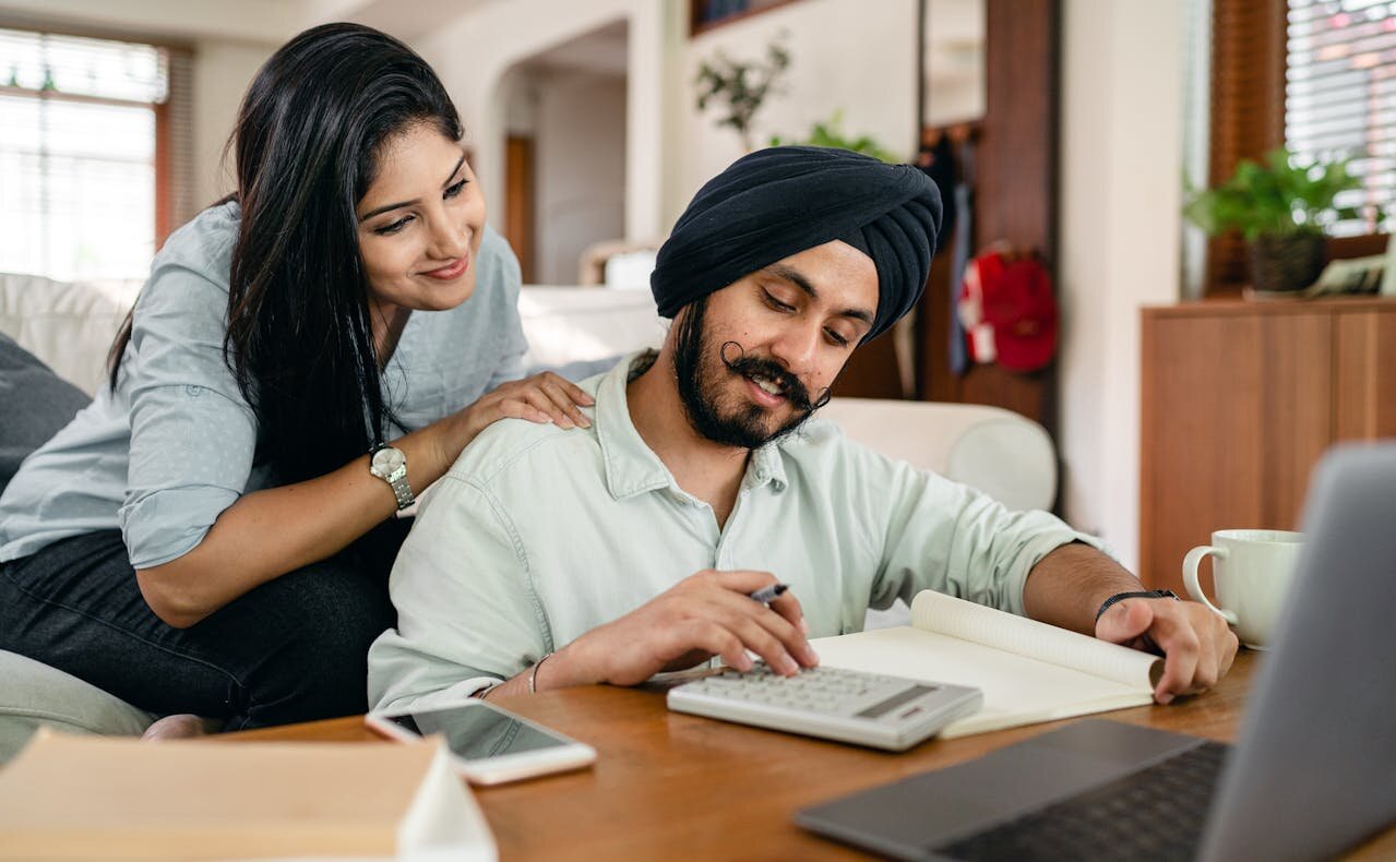 Young smiling couple reviewing their finances