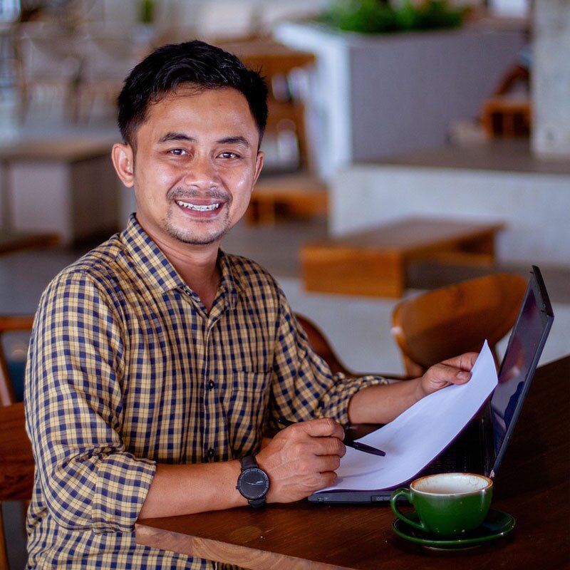 Happy man applying for a home improvement credit line from a laptop