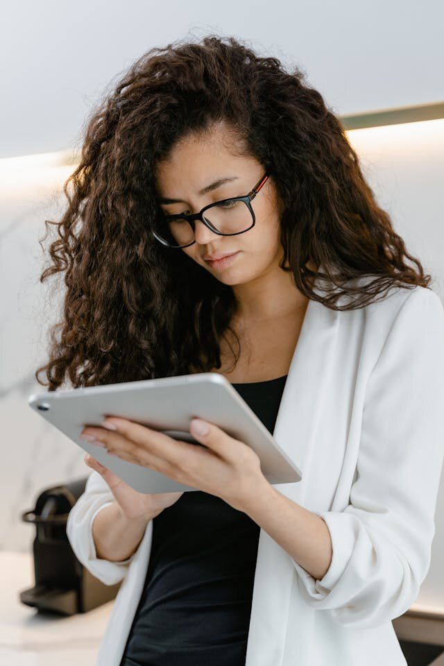 Young woman using a tablet to apply for a line of credit.