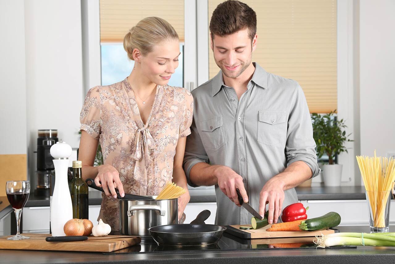 Happy couple cooking together in their improved kitchen