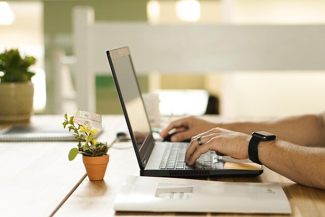 Man typing on a laptop