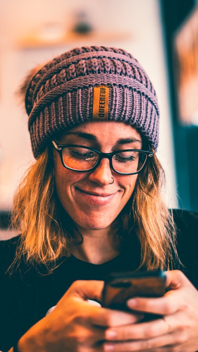 Woman smiling using a smartphone
