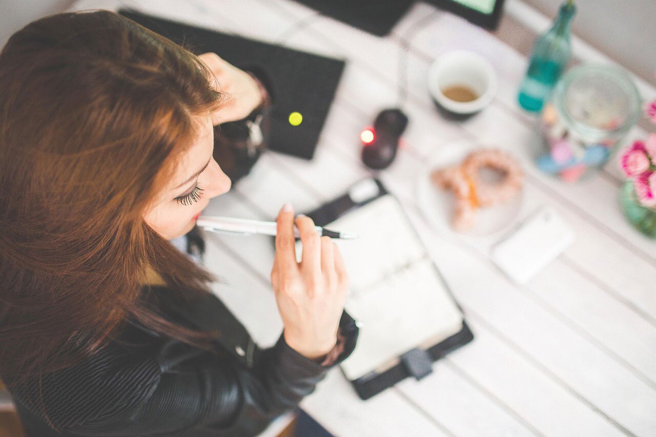 Woman seated at a desk budgeting