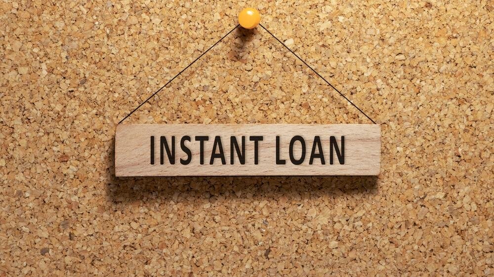 Instant loan sign hanging from a pin