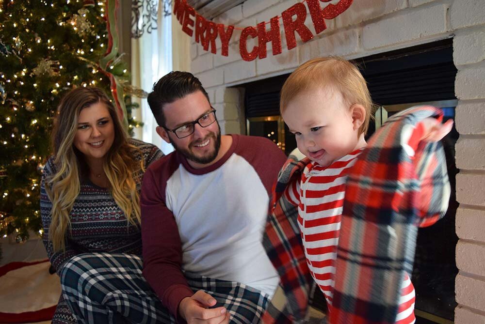 Family unpacking gifts on Christmas morning.