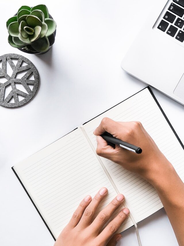 Person scribbling in a notebook