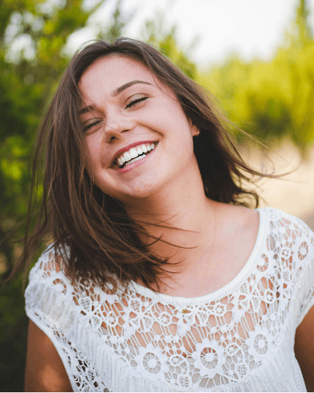 Woman wearing white top smiling