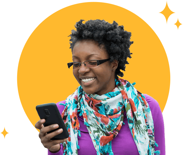 A smiling woman looking at her online installment loan approval on her phone.