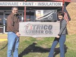 Workers holding the Trico's store sign