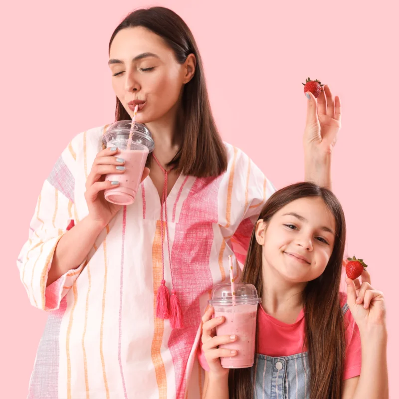 Mother and daughter enjoying healthy smoothies with GreenPeach liquid vitamins
