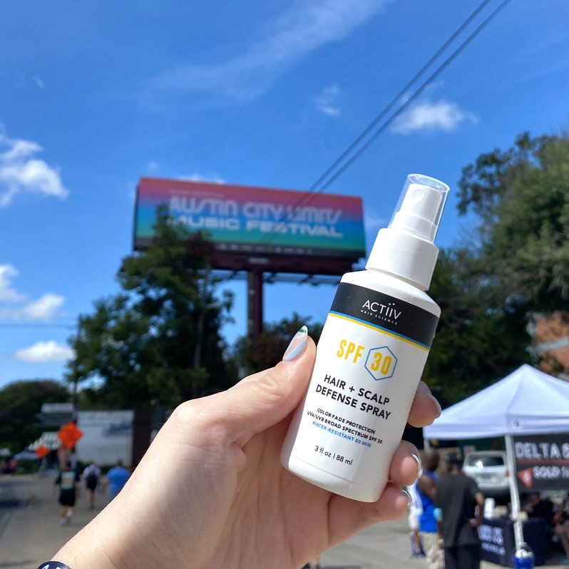 Actiiv SPF Spray in front of Austin City Limits billboard