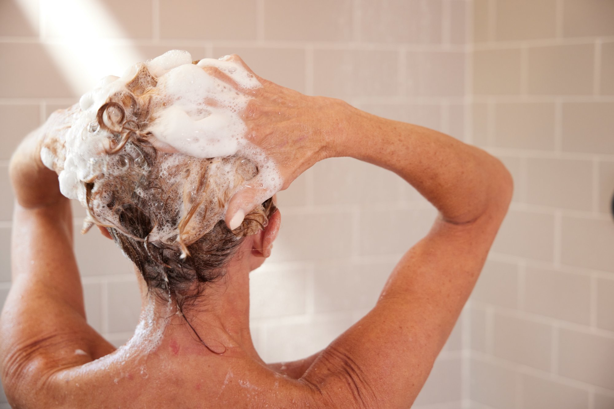 Woman washing hair in the shower