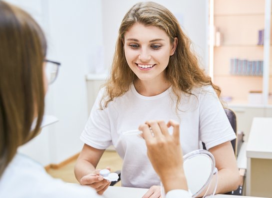 optician giving a patient contact lenses at an aftercare appointment