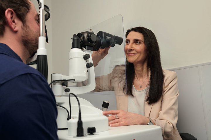 Optician testing a patient's eyes