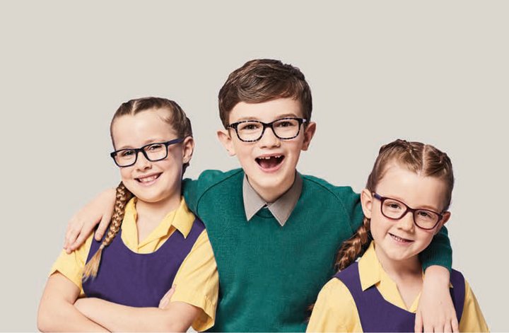 three young children wearing NHS prescription glasses
