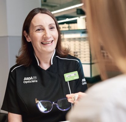 ASDA Opticians staff member greeting a patient who has come for an eye test