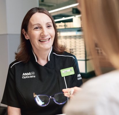 Optician from ASDA giving guidance with a smile