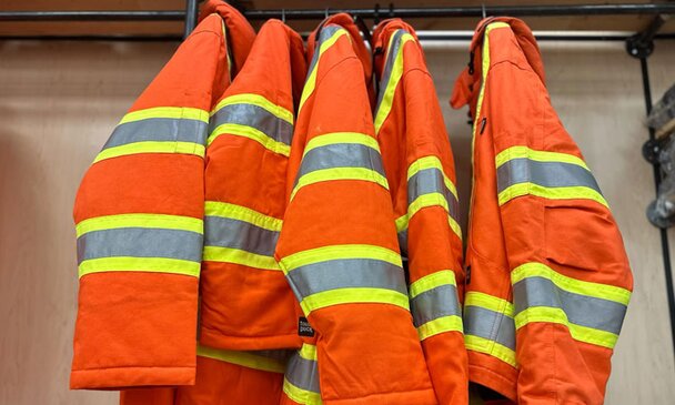 A group of high-vis jackets hung together at Got Wood Building Supplies.